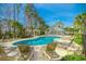 Community pool with sun loungers and lush landscaping on a sunny day at 1033 World Tour Blvd. # 203, Myrtle Beach, SC 29579