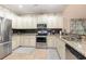 Well-lit kitchen boasts stainless steel appliances, ample white cabinetry, and granite countertops at 1105 Dinger Ct. # 1105, Myrtle Beach, SC 29588