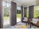 Sunroom with windows, shades and view to the yard and two wicker chairs at 1105 Dinger Ct. # 1105, Myrtle Beach, SC 29588