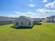 Expansive backyard with lush green lawn and a view of neighboring homes under a bright sky at 1106 Cherrystone Loop, Conway, SC 29526