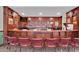 Luxurious bar area featuring rich wood finishes, a well-stocked bar, and comfortable seating at 1106 Cherrystone Loop, Conway, SC 29526