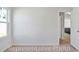 Bright bedroom featuring plush carpeting and a doorway leading to the kitchen at 1106 Cherrystone Loop, Conway, SC 29526