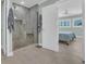 Walk-in shower with a tiled bench and a glass enclosure, complemented by a bright bedroom in the background at 112 Spartina Ct. # 26, Pawleys Island, SC 29585
