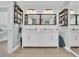 Bright bathroom with double sink vanity, marble countertops, and decorative shelving units, creating an elegant space at 112 Spartina Ct. # 26, Pawleys Island, SC 29585