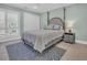 Comfortable bedroom boasts a stylish bed and plenty of natural light from a large window at 112 Spartina Ct. # 26, Pawleys Island, SC 29585