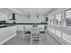 Bright kitchen with white cabinets, marble countertops, modern appliances, and round kitchen table with seating at 112 Spartina Ct. # 26, Pawleys Island, SC 29585