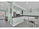 Bright kitchen with white cabinets, marble countertops, stainless steel appliances, and open layout at 112 Spartina Ct. # 26, Pawleys Island, SC 29585