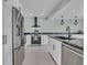 Modern kitchen with stainless steel appliances, granite countertops, sleek cabinetry, and updated lighting at 112 Spartina Ct. # 26, Pawleys Island, SC 29585