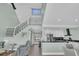 Open-concept living room featuring staircase and open kitchen with modern decor at 112 Spartina Ct. # 26, Pawleys Island, SC 29585