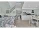 Bright open-concept living room with open staircase and modern kitchen at 112 Spartina Ct. # 26, Pawleys Island, SC 29585