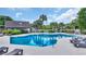 Community pool area with lounge chairs, palm trees, and well maintained landscaping, offering a relaxing atmosphere at 112 Spartina Ct. # 26, Pawleys Island, SC 29585