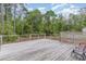 Back deck provides outdoor space, wooden construction, and decorative paneling at 113 Winding Path Dr., Loris, SC 29569