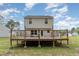 Elevated backyard deck provides outdoor living space and views of the surrounding yard at 113 Winding Path Dr., Loris, SC 29569
