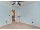Cozy bedroom features blue walls, a ceiling fan, and access to a closet at 113 Winding Path Dr., Loris, SC 29569