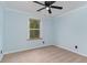 Bright bedroom with blue walls, ceiling fan, and a large window at 113 Winding Path Dr., Loris, SC 29569
