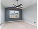 This bedroom has neutral carpet, ceiling fan and a window with a blue wall accent at 113 Winding Path Dr., Loris, SC 29569