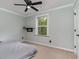Comfortable bedroom with neutral tones, ceiling fan, and built-in desk area at 113 Winding Path Dr., Loris, SC 29569