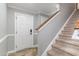 Home entryway with a staircase, neutral color scheme, tiled floor, and white door at 113 Winding Path Dr., Loris, SC 29569