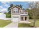 Charming two-story home featuring a covered entryway, attached garage, and well-maintained landscaping at 113 Winding Path Dr., Loris, SC 29569