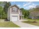 Charming two-story home featuring an attached garage, concrete driveway, and well-maintained landscaping at 113 Winding Path Dr., Loris, SC 29569