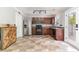 Well-lit kitchen with stainless steel refrigerator and a rustic wood accent wall at 113 Winding Path Dr., Loris, SC 29569