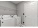Laundry room with a door and washer and dryer with overhead shelving at 113 Winding Path Dr., Loris, SC 29569