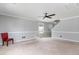 Large living room with carpet, neutral paint, and two windows for ample natural light at 113 Winding Path Dr., Loris, SC 29569