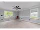 Spacious main bedroom with a ceiling fan, neutral paint, large windows, and carpeted flooring at 113 Winding Path Dr., Loris, SC 29569