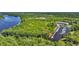 Aerial view of a marina with boats docked, surrounded by lush greenery and a large body of water at 115 Harbor Club Dr. # 4A, Pawleys Island, SC 29585