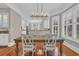 Open dining room with hardwood floors, wainscotting and view to the kitchen at 115 Harbor Club Dr. # 4A, Pawleys Island, SC 29585