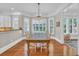 Bright dining room boasts hardwood floors, a large table, and natural light at 115 Harbor Club Dr. # 4A, Pawleys Island, SC 29585