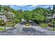 Community entrance with a roundabout, manicured landscaping, and trees at 115 Harbor Club Dr. # 4A, Pawleys Island, SC 29585