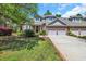 Charming brick home featuring a well-manicured lawn, attached garages, and inviting curb appeal at 115 Harbor Club Dr. # 4A, Pawleys Island, SC 29585
