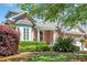 Beautiful brick home with a well-kept lawn and garden, featuring a covered front porch at 115 Harbor Club Dr. # 4A, Pawleys Island, SC 29585
