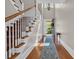 Elegant foyer showcasing hardwood floors, a staircase, and a view through to the front door at 115 Harbor Club Dr. # 4A, Pawleys Island, SC 29585