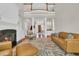 Spacious living room featuring a fireplace, staircase, and comfortable seating arrangement at 115 Harbor Club Dr. # 4A, Pawleys Island, SC 29585