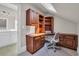 Bright office space featuring wood built-ins, desk, and a skylight for natural light, next to a bathroom at 115 Harbor Club Dr. # 4A, Pawleys Island, SC 29585