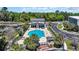 Aerial view of a community pool, clubhouse, and marina with boats docked on a sunny day at 115 Harbor Club Dr. # 4A, Pawleys Island, SC 29585