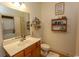 Comfortable bathroom featuring a vanity, toilet, mirror, and stackable washer and dryer unit at 118 Ella Kinley Circle # 404, Myrtle Beach, SC 29588