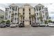 Condo exterior featuring multiple units, covered stairwells, and parking at 118 Ella Kinley Circle # 404, Myrtle Beach, SC 29588