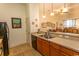 Open kitchen with wood cabinets, appliances, and a breakfast bar connecting to the living space at 118 Ella Kinley Circle # 404, Myrtle Beach, SC 29588
