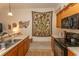 Functional kitchen featuring wood cabinets, black appliances, and neutral countertops and flooring at 118 Ella Kinley Circle # 404, Myrtle Beach, SC 29588