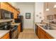 Functional kitchen features warm wood cabinetry, a sink, and seamless access to other spaces at 118 Ella Kinley Circle # 404, Myrtle Beach, SC 29588