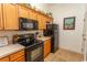 Charming kitchen includes wooden cabinets, a stove, refrigerator, and modern appliances at 118 Ella Kinley Circle # 404, Myrtle Beach, SC 29588