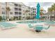 Inviting community pool with lounge chairs and seating surrounded by palm trees and condo buildings at 118 Ella Kinley Circle # 404, Myrtle Beach, SC 29588