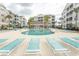 Community pool featuring plentiful lounge seating, palm trees and multiple condo buildings at 118 Ella Kinley Circle # 404, Myrtle Beach, SC 29588