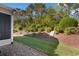 Landscaped backyard featuring mature trees, mulch beds, and green grass at 120 Carolina Crossing Blvd., Little River, SC 29566