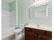 Well-lit bathroom with a tub, single sink vanity and decorative wallpaper at 120 Carolina Crossing Blvd., Little River, SC 29566