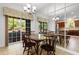 Bright dining area with wood table, mirrored wall, and sliding glass doors to the outdoor space at 120 Carolina Crossing Blvd., Little River, SC 29566