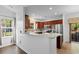 Bright kitchen with a breakfast bar, wood cabinetry, and stainless steel appliances, making it a delightful place to prepare meals at 120 Carolina Crossing Blvd., Little River, SC 29566